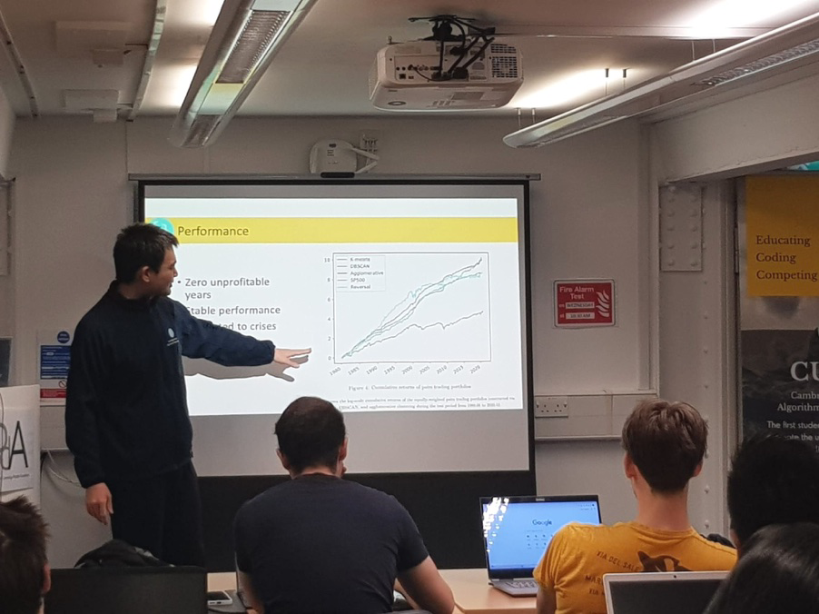 Dequn Teng leading a quantitative-finance session at CUATS, presenting at the screen to students